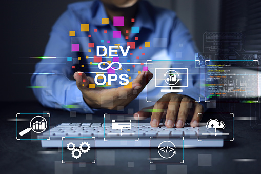 devops engineer or development operation software developer programmer holding dev and ops icon in hand while working with laptop to deploy code and software monitor on agile working concept.