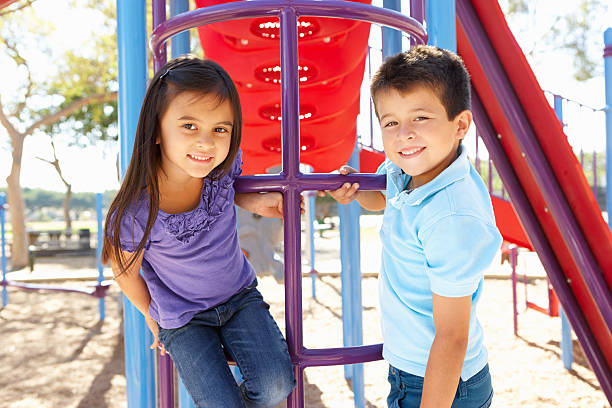 rapaz e rapariga com moldura de escalada no parque - playground schoolyard playful playing imagens e fotografias de stock