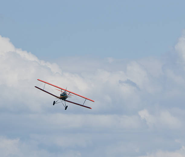 istock Front view of a biplane head-on in flight in a cloudy sky. 178493363