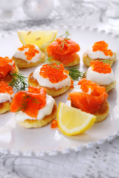 istock Appetizer with caviar and salmon on white plate. 178493524