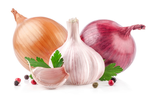 Garlic and onion with parsley isolated on white background