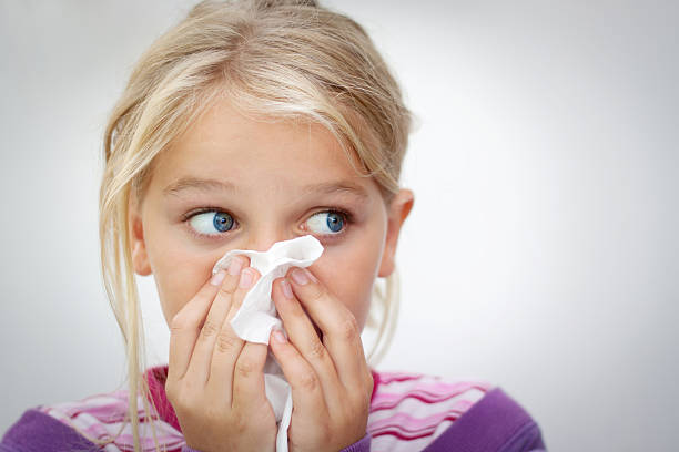 Child with cold Girl blowing her nose. Space for text. Horizontal cold virus stock pictures, royalty-free photos & images