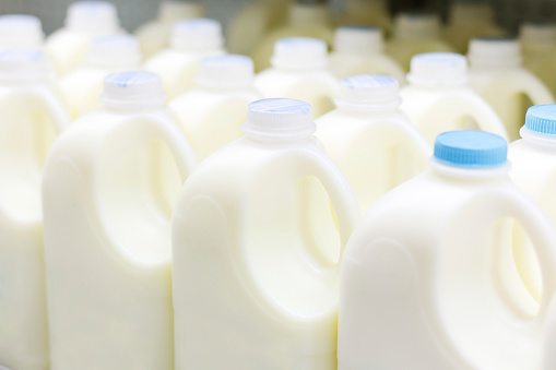 Plastic bottles of milk on factory production line