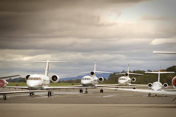 Six aircrafts lined up on tarmac on an overcast day