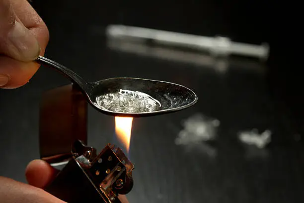 Close up of person cooking heroin