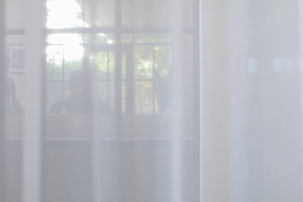 istock White curtain with texture for see through and soft light. Interior decoration on morning warm sunlight for background 1784940216