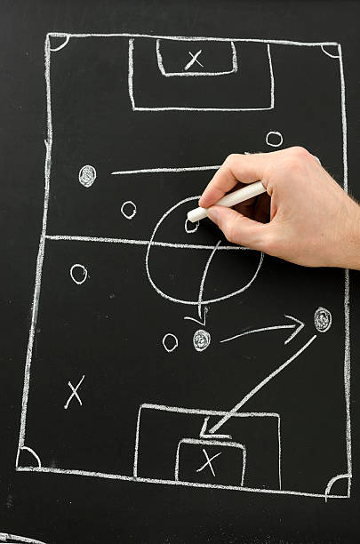 istock Hand draws football play on a chalkboard 178494354