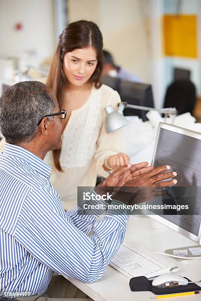 Workers At Desks In Busy Creative Office Stock Photo - Download Image Now - Discussion, Two People, 20-29 Years