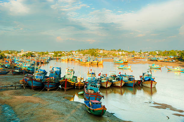istock Fishing boats in harbor under sunset 178495533