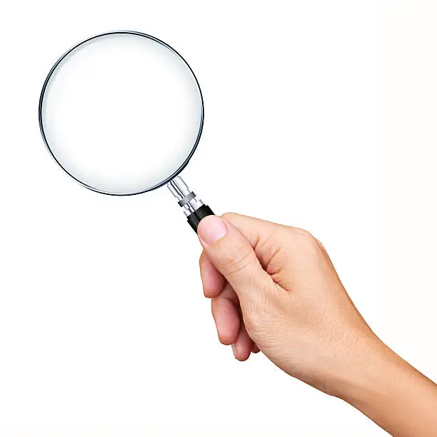 Photo of Hand holding magnifying glass isolated on white background