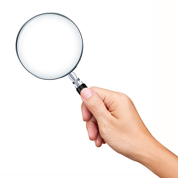 hand holding magnifying glass isolated on white background - förstoringsglas bildbanksfoton och bilder