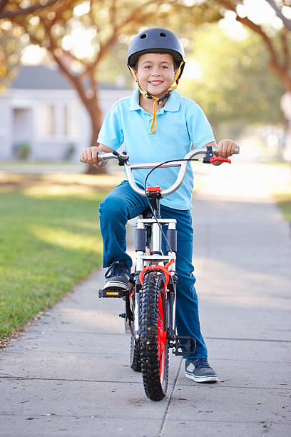 istock Boy Wearing Safety Helmet Riding Bike 178496452