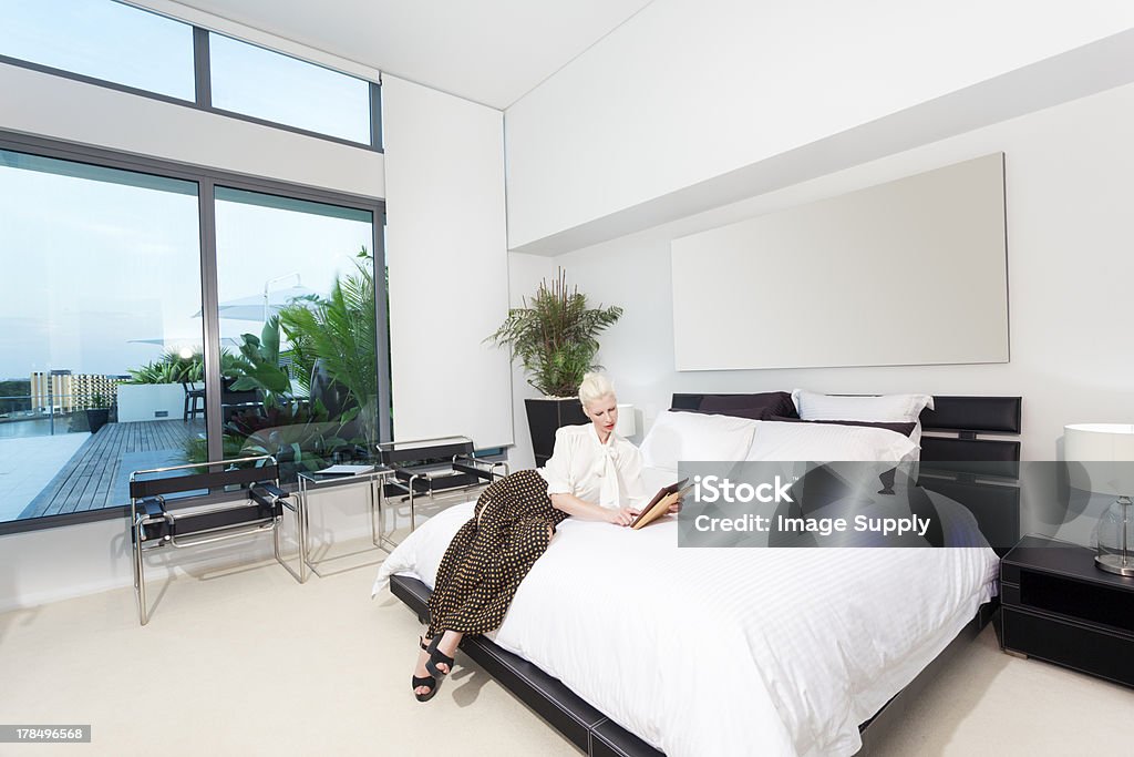 Woman in bedroom Attractive woman in modern bedroom Australia Stock Photo