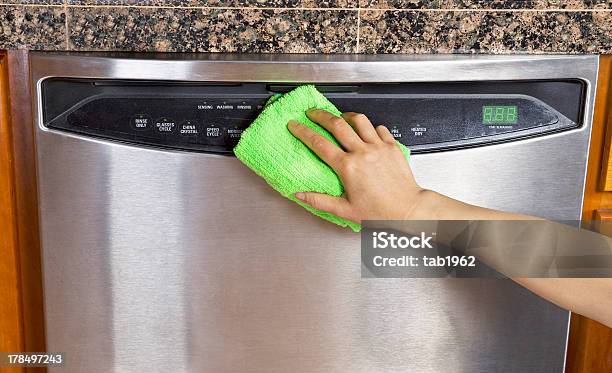 Wiping Clean A Silver Dishwasher With A Microfiber Rag Stock Photo - Download Image Now