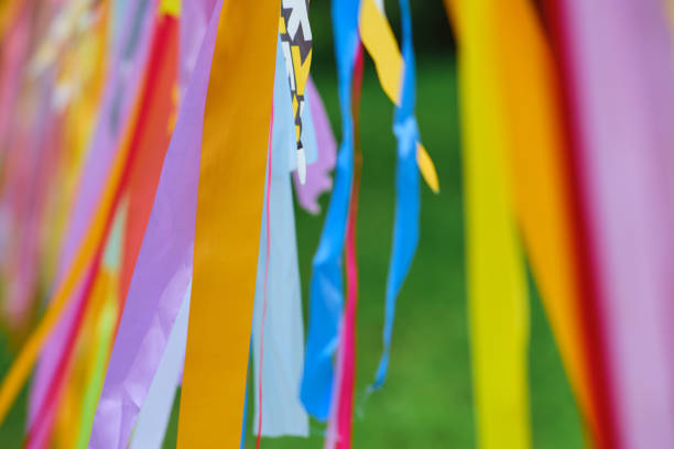 istock Background of multicolored ribbons hanging in nature and developing in the wind 1784972650
