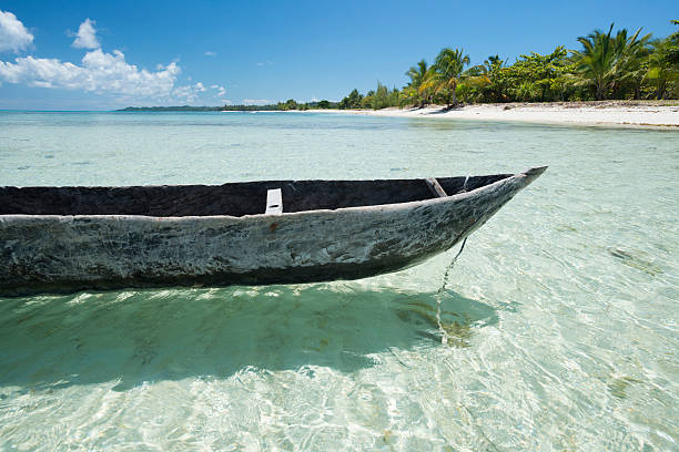 Wooden traditional canoe Wooden canoe in a idyllic remote beach in the northern of Madagascar madagascar beach photos stock pictures, royalty-free photos & images