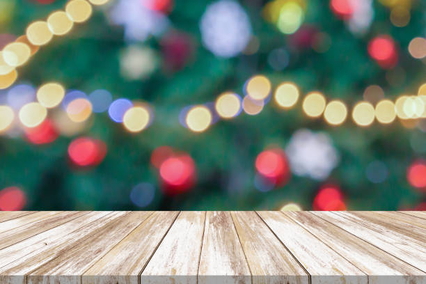 istock Empty wood table top with blur Christmas tree with bokeh light background 1784986475