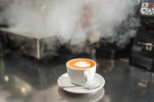 Delight your senses with the captivating aroma and taste of a hot coffee cup beckoning from the bar counter.