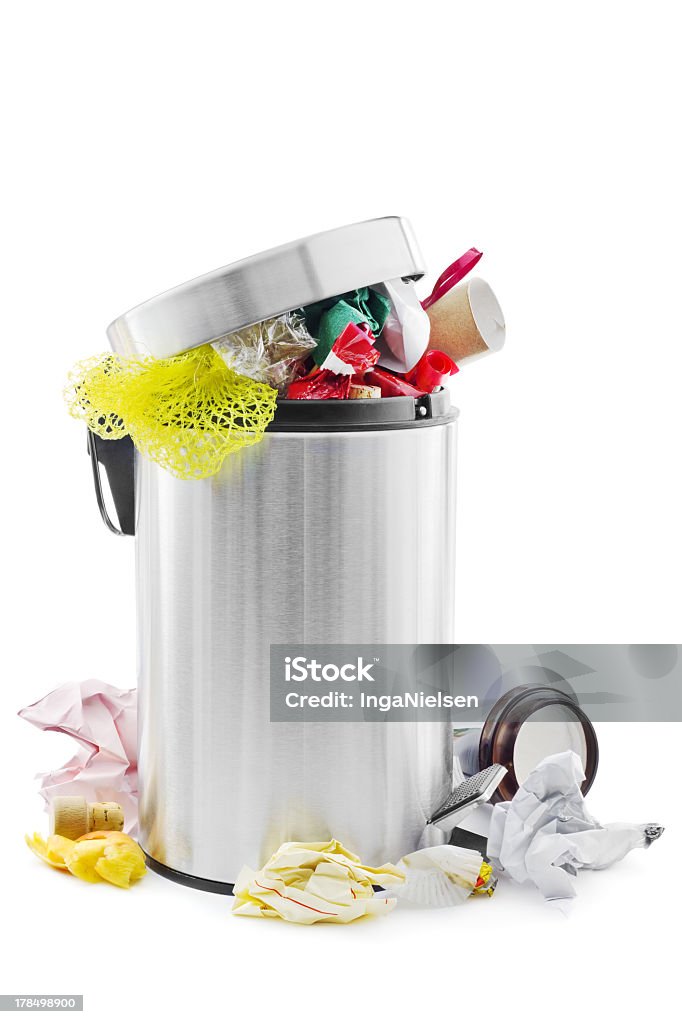 Overflowing stainless steel trash can Over full trash can on white. Garbage Can Stock Photo