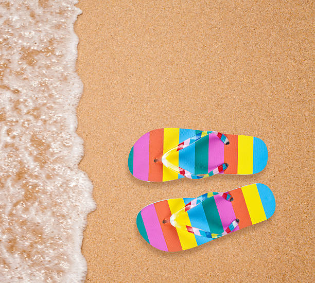 istock Colorful flipflop pair on sea beach 178499382