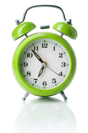 Old-fashioned alarm clock on white background