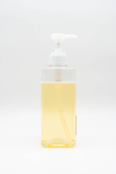 istock Yellow liquid soap or shampoo by pouring it from a refill to reduce plastic waste. Sustainable Zero Waste. 1784998699