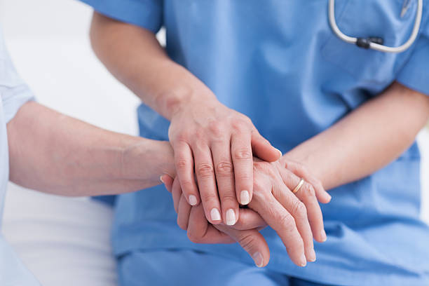 istock Close up of nurse touching the patient hand 178500680