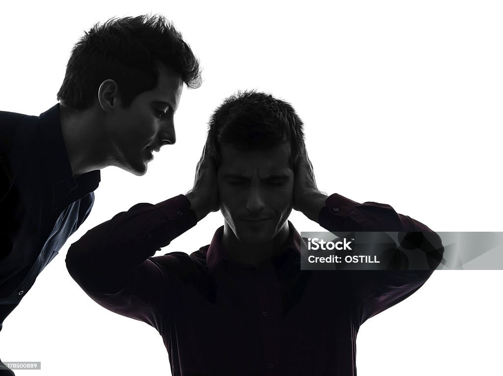 one man hearing voices two caucasian young men domination concept shadow  white background Adult Stock Photo