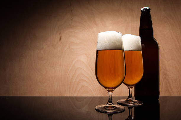 Two glasses and bottle with beer stock photo