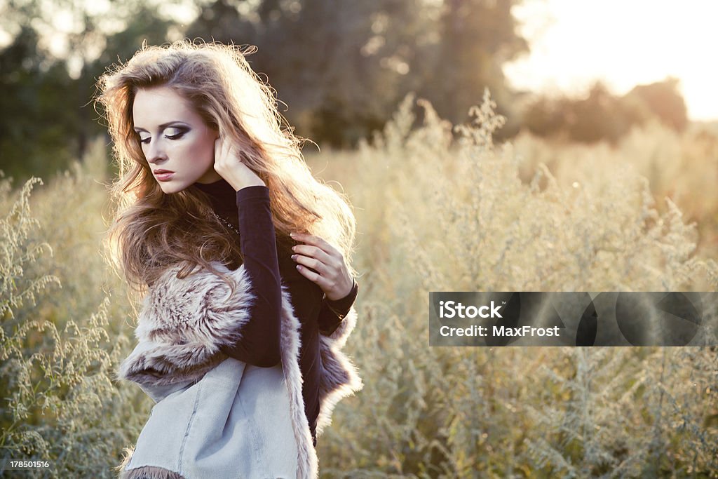 Young woman outdoors fashion portrait. Young woman outdoors fashion portrait. Soft sunset light Adult Stock Photo
