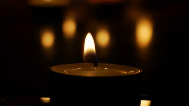 istock candle, blurred, darkness, flame, holy, hope, memorial, peace, religion, bokeh, burn, death, effect, glowing 1785019149
