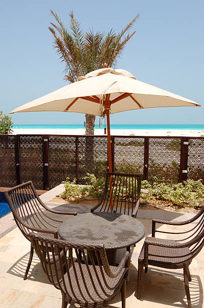 istock Chairs and umbrella near swimming pool by a beach 178503549