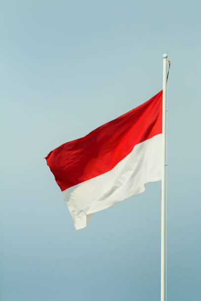 istock a red and white flag waving in the wind. 1785036847