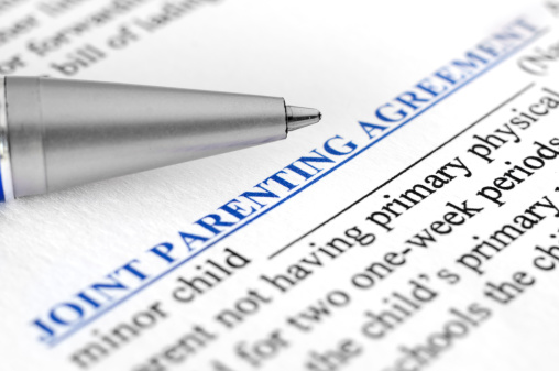 Close-up of Joint parenting agreement with pen