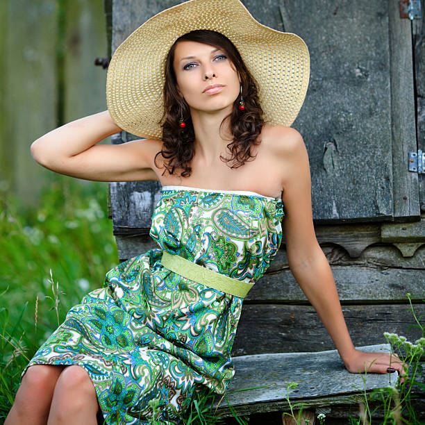 beautiful girl in a straw hat for a walk in the countryside