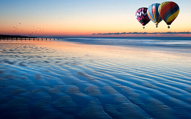 istock Hot air balloons over beautiful low tide beach vibrant sunrise 178505362
