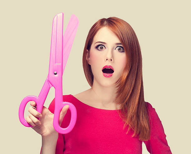istock Redhead girl with big scissors 178505424