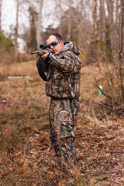 istock Young man in woods aims rifle 178505469