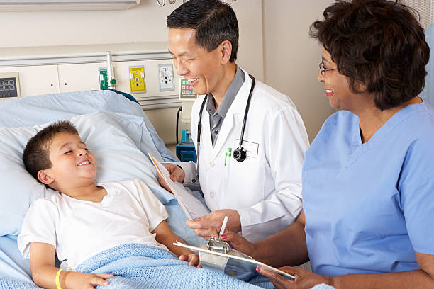 istock Doctor And Nurse Visiting Child Patient On Ward 178505531