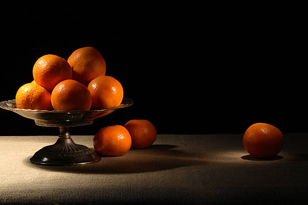 Tangerines In Bowl Vintage brass fruit bowl with tangerines on canvas surface antique fruit bowl stock pictures, royalty-free photos & images