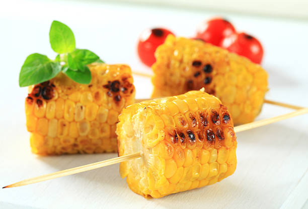 istock Three small grilled corn on the cob on skewers 178505912