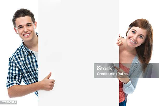Smiling Teenagers Behind White Wall Stock Photo - Download Image Now - Teenager, Pointing, Thumbs Up