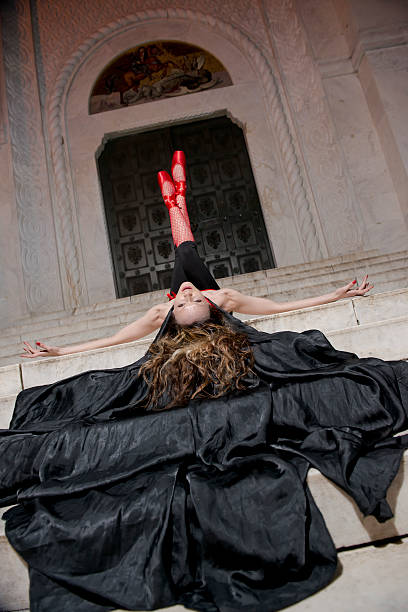 istock Ballerina in red and black laying on her back 178506144