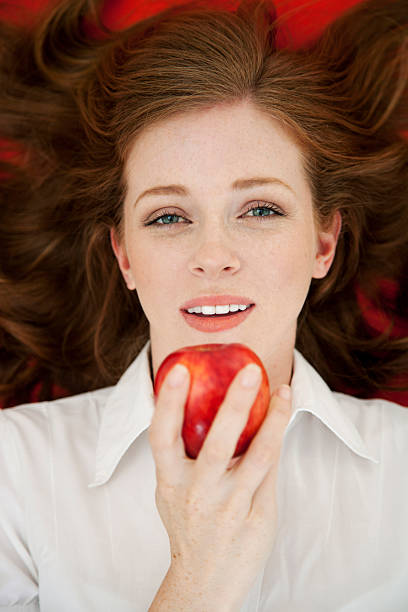 istock Woman eating apple from above 178506398