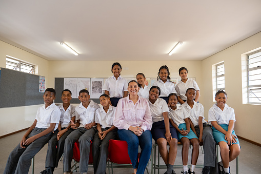 Classroom photo of a teacher and her pupils in their classroom from a rural school near Cape Town in South Africa