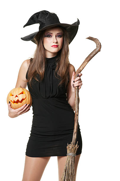 istock The  young serious brunette witch with a broom 178506952