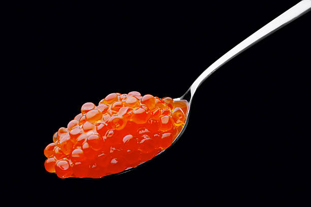 istock The spoon with red caviar on a black background 178507050