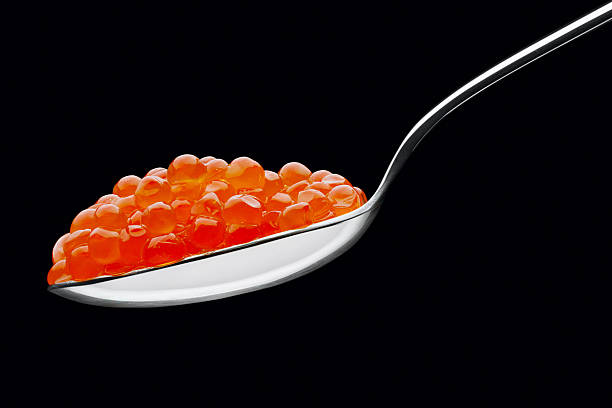 istock The spoon with red caviar on a black background 178507169