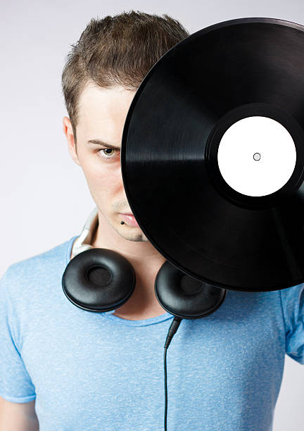 istock Young man covering his face with a vinyl disc 178507256