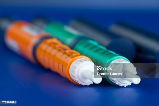 Close Up Of Green And Orange Insulin Syringe Pens Stock Photo - Download Image Now - Insulin, Pen, Care